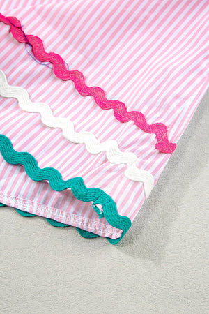 Blush pink and white striped blouse with scalloped trim in pink, white, and teal.