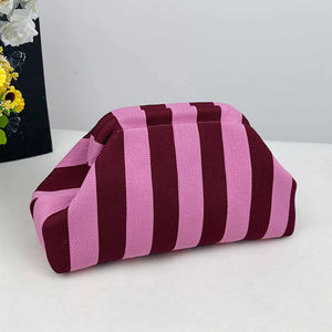 Vibrant knit clutch with striking pink and burgundy stripes.