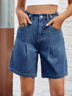 Pleated denim bermuda shorts in medium wash with buttoned fly and front pockets.
