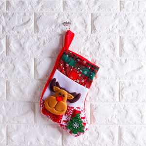 Festive holiday stocking with reindeer and Christmas tree applique, red plaid cuff.