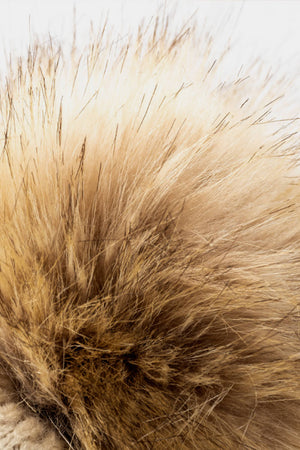 Beige beanie with textured leopard print and fluffy pom detail.