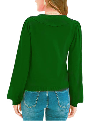 Green knit cardigan with scalloped collar and balloon sleeves.