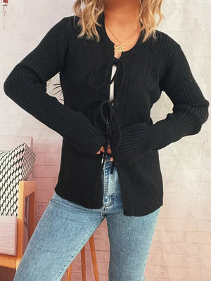 Black ribbed tie-front cardigan with cuffed sleeves and a round neckline.
