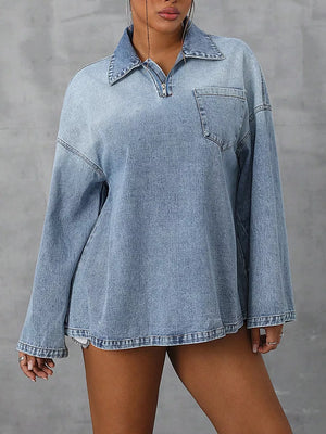 Collared denim top with quarter zip and chest pocket in light blue wash.