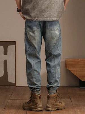 Relaxed fit vintage wash denim jeans with unique paneling and a tapered leg