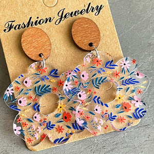 Floral acrylic bloom earrings with wood tops, featuring a colorful floral pattern.