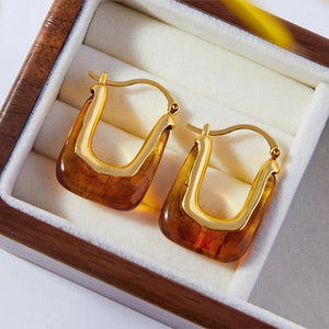 Gold geometric hoop earrings with amber resin detail