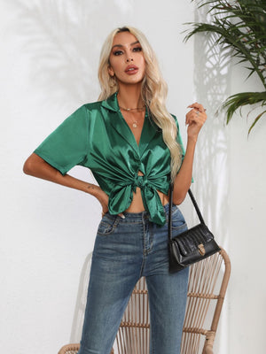 Emerald green satin collared shirt with short sleeves, tied at the waist.