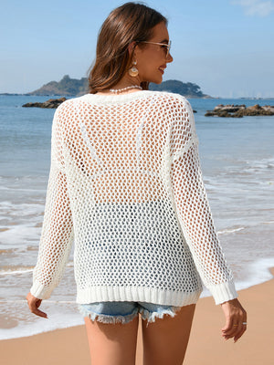 White open-knit beach sweater with ribbed trim and long sleeves.