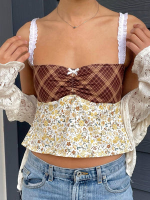 Mixed print corset cami with white lace straps and a small bow detail.