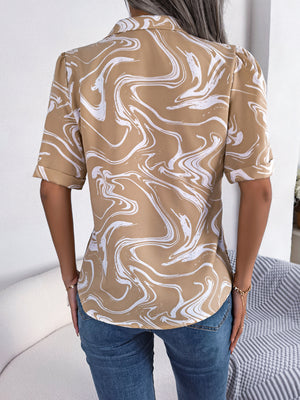 Khaki swirl print camp collar blouse with short sleeves and rolled cuffs.