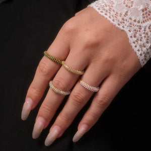 Pavé Zirconia Band Ring in white and dark green, stacked on a hand.