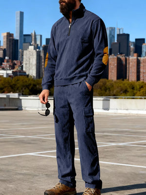 Navy blue corduroy two-piece set with quarter zip pullover and cargo pants.