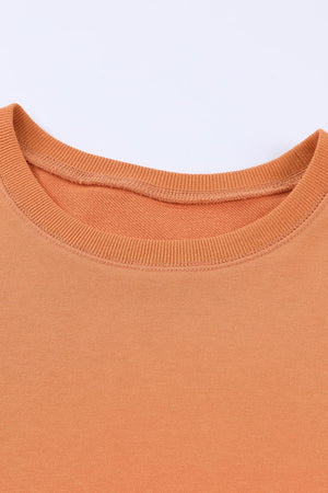 Orange crewneck sweatshirt with ribbed neckline and cuffs