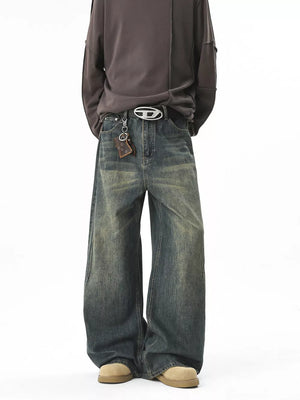 Men's vintage wash baggy blue cotton jeans with a belted waist and keychain detail.