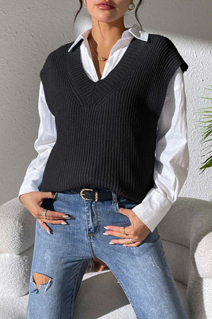 Black textured knit v-neck sleeveless top over a white button-down shirt.