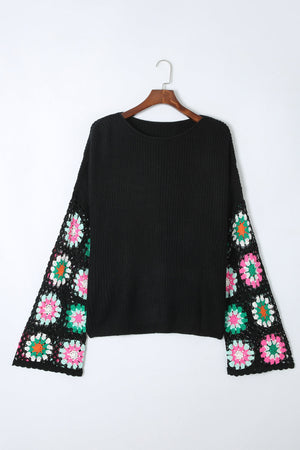 Black knit pullover sweater with crochet granny square bell sleeves in colorful floral patterns.