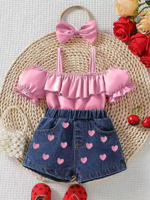Pink ruffled off-shoulder top and denim shorts with pink hearts, includes matching bow headband.