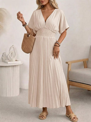 Apricot V-neck midi dress with smocked waist and pleated skirt.