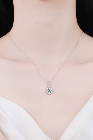Sterling silver necklace with a halo moissanite teardrop pendant.