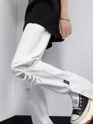 White distressed loose-fit jeans with snap detail and adjustable hem.