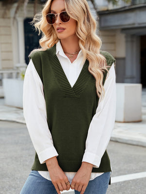Army green ribbed knit v-neck sweater vest styled over a white button-down shirt.