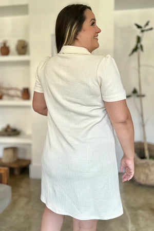 Ivory textured short sleeve mini dress with V-neck and collar