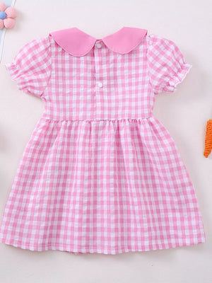Pink gingham baby dress with Peter Pan collar, puff sleeves, and bunny embroidery detail.