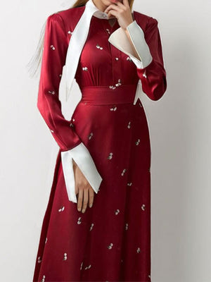 Burgundy midi dress with contrast collar, defined waist, and white floral print.