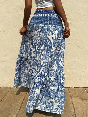 Bohemian paisley maxi skirt in blue with smocked waist and tiered ruffles.