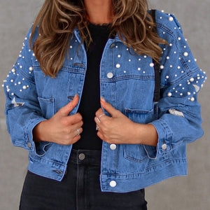 Denim jacket with pearl embellishments and star details on sleeves.