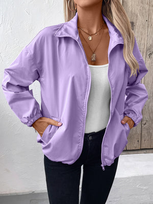 Lavender nylon bomber jacket with zip front, elastic cuffs, and drawstring hem.