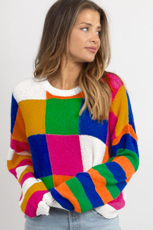 Patchwork knit crewneck pullover sweater with bold color blocks and stripes in acrylic.