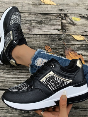 Black platform sneakers with gemstone panels and gold accents.