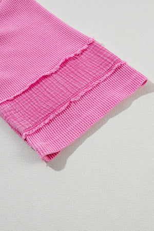 Waffle knit top in fuchsia pink with raw seam detail and textured stripe panel.