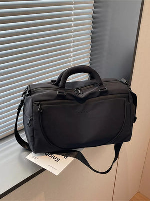 Black medium duffle bag with adjustable strap and dual top handles.