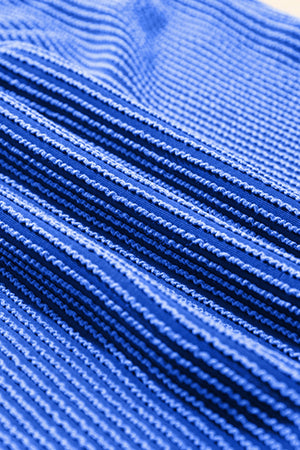 Textured ribbed polo short set in royal blue with a close-up view of the fabric's ribbed pattern.