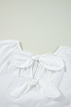 White babydoll blouse with square neckline and two front bow details.