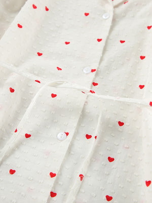 White cotton pajama set with red heart print, button-down front, and tie waist.