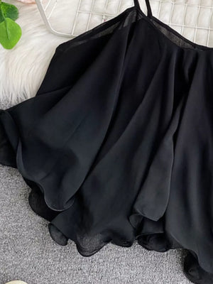 Black ruffled camisole with spaghetti straps and delicate hem detail