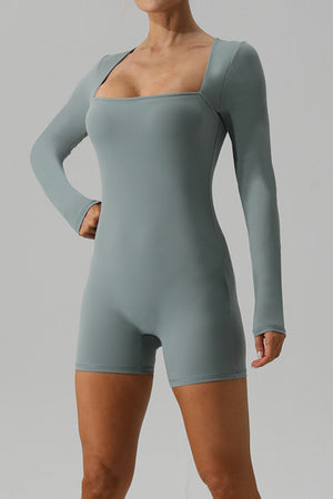 Light green long sleeve unitard with square neckline and short legs.