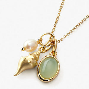 Gold seashell and gemstone charm necklace with pearl detail
