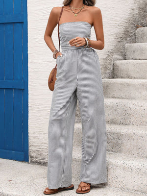 Strapless wide leg romper in navy and white stripes, cotton blend, with a cinched waist and pockets.