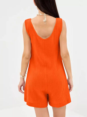 Orange crinkled cotton sleeveless button-down romper with a V-neck.