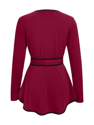 Burgundy peplum blouse with long sleeves, tie detail at waist, and black trim.