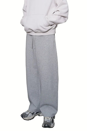 Relaxed-fit lounge trousers in heather gray with a drawstring waist and wide leg.