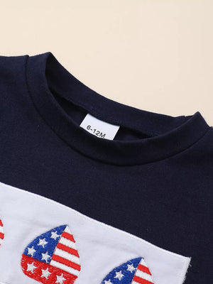 Navy baby set with embroidered American flag hearts on a white stripe.