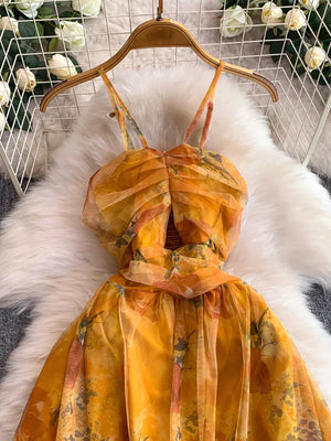 Yellow floral mesh maxi dress with ruched bodice and spaghetti straps.