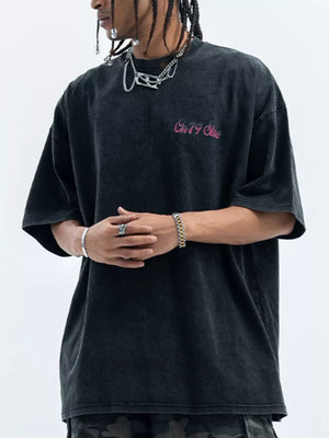 Men's black washed cotton t-shirt with pink graphic logo and crew neck.