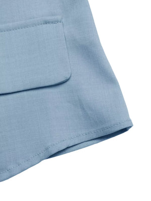 Light blue buttoned vest detail with a flap pocket and clean stitching.